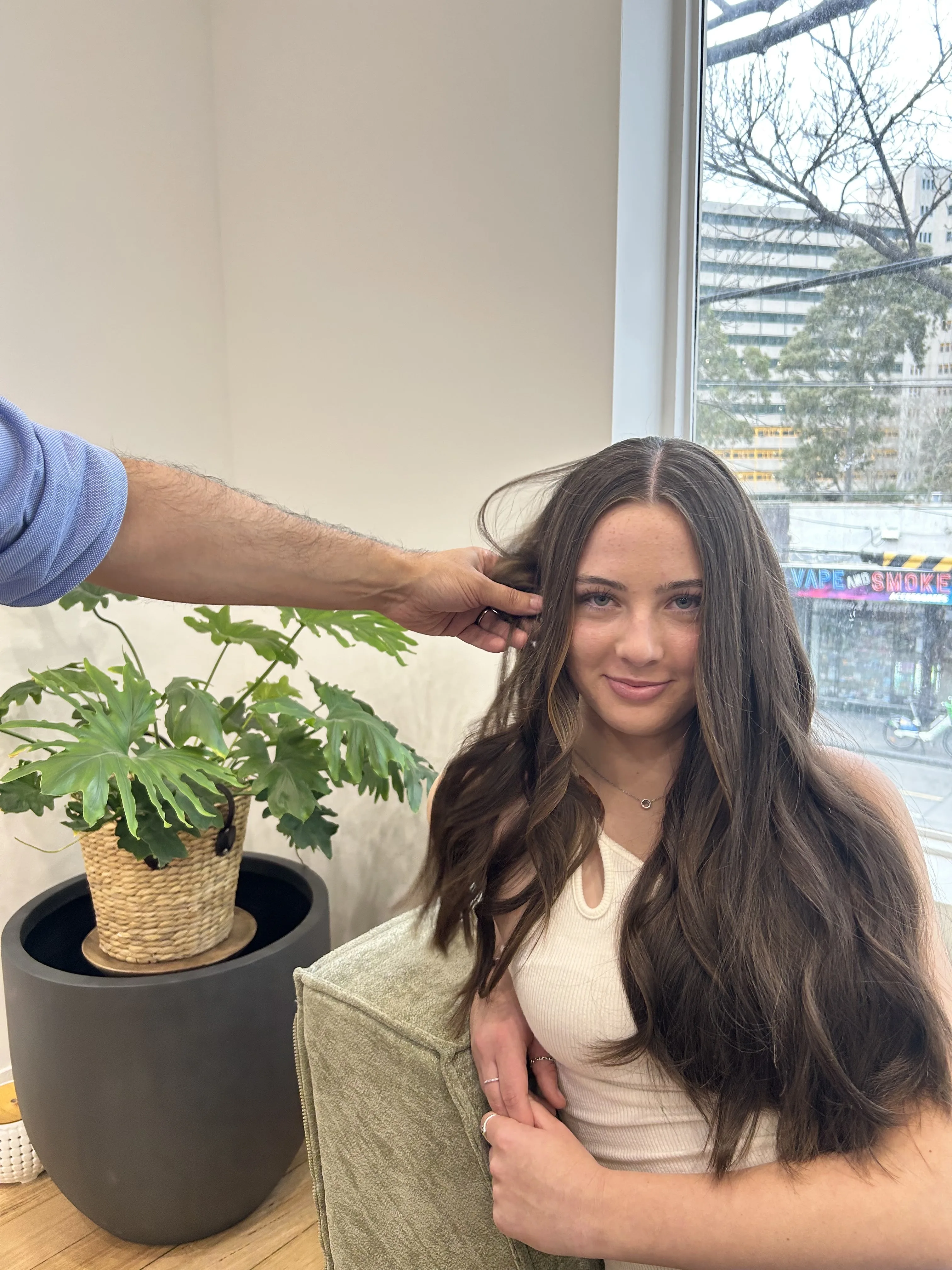 Seated client with very long dark-brunette waves