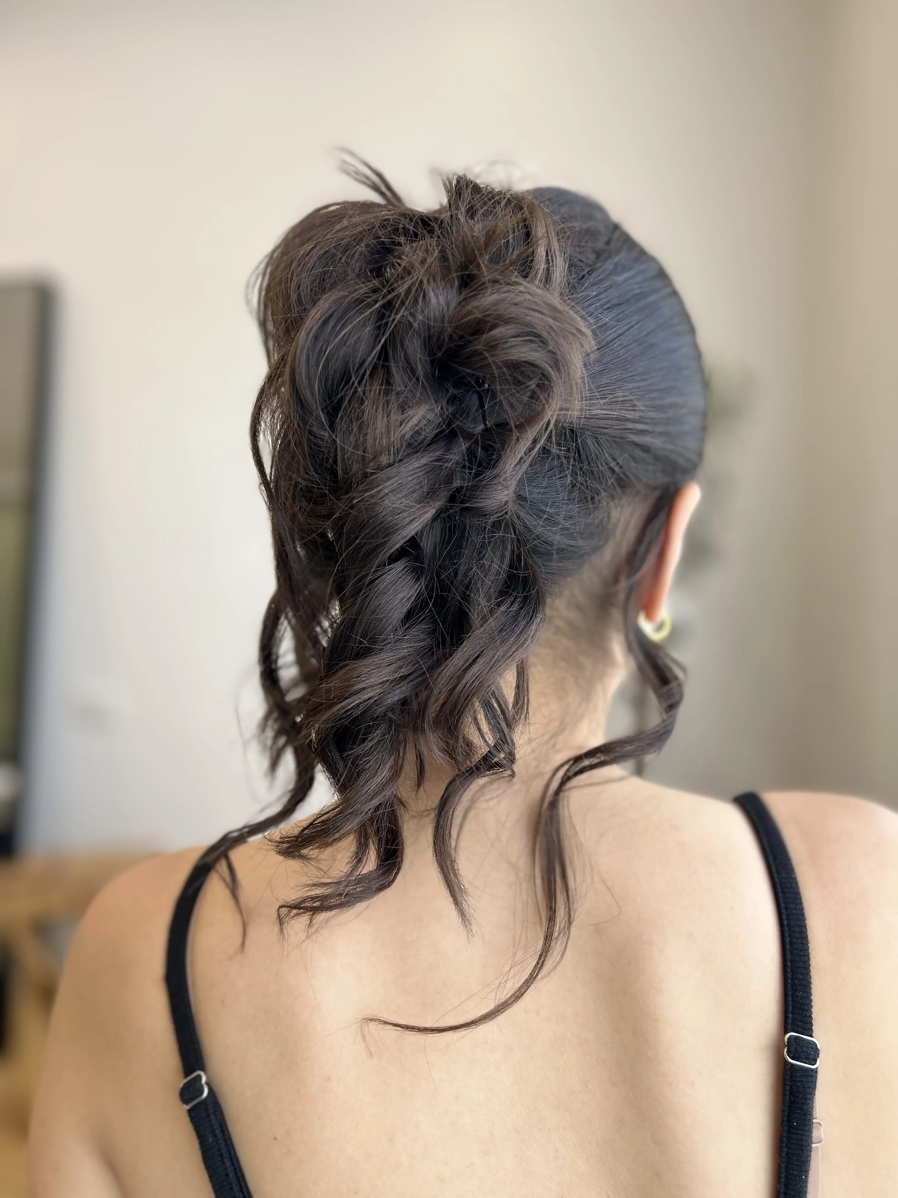 Dark-brunette updo with loose tendrils, back view
