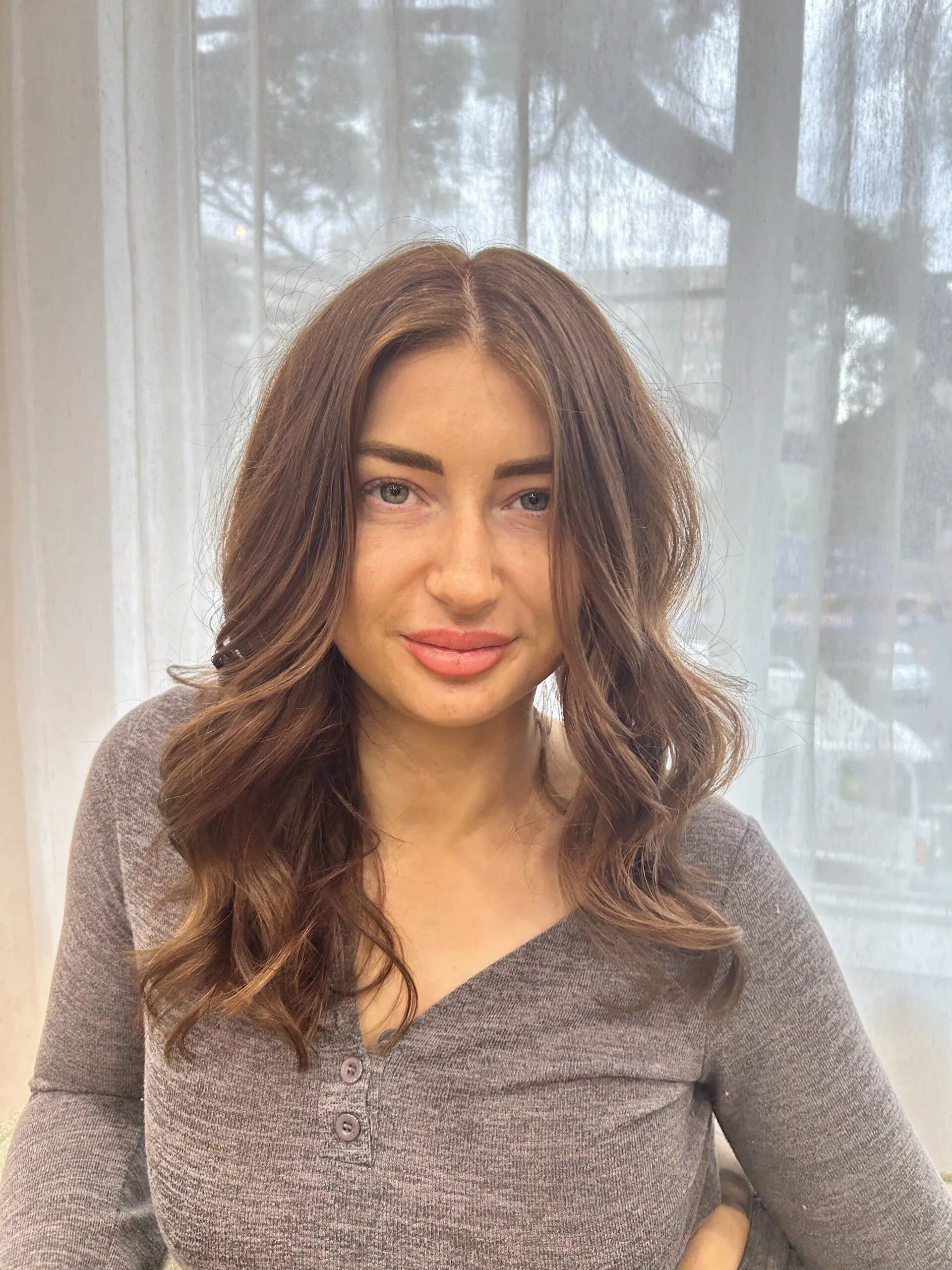 Mid-length soft brunette waves with warm face-framing